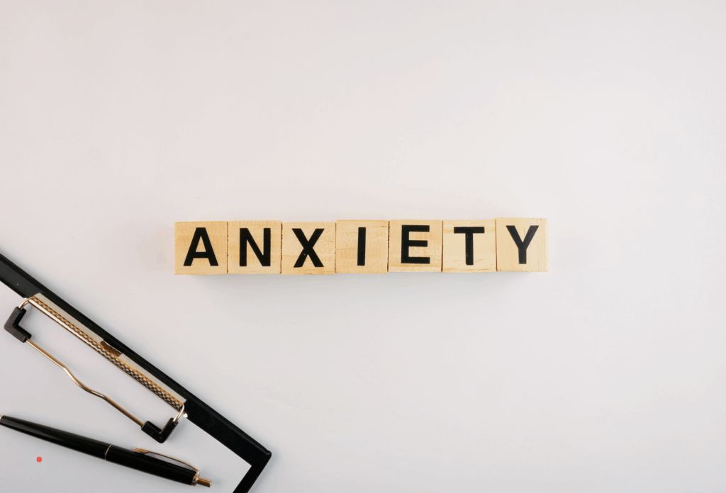 wooden letter tiles spelling “anxiety” to represent anxious thoughts