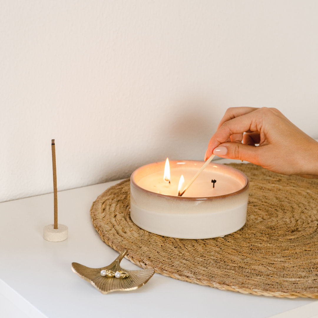 lighting a candle as part of a quiet writing or reflection ritual