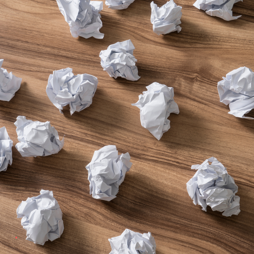 crumpled paper balls symbolizing discarded thoughts and mental clutter