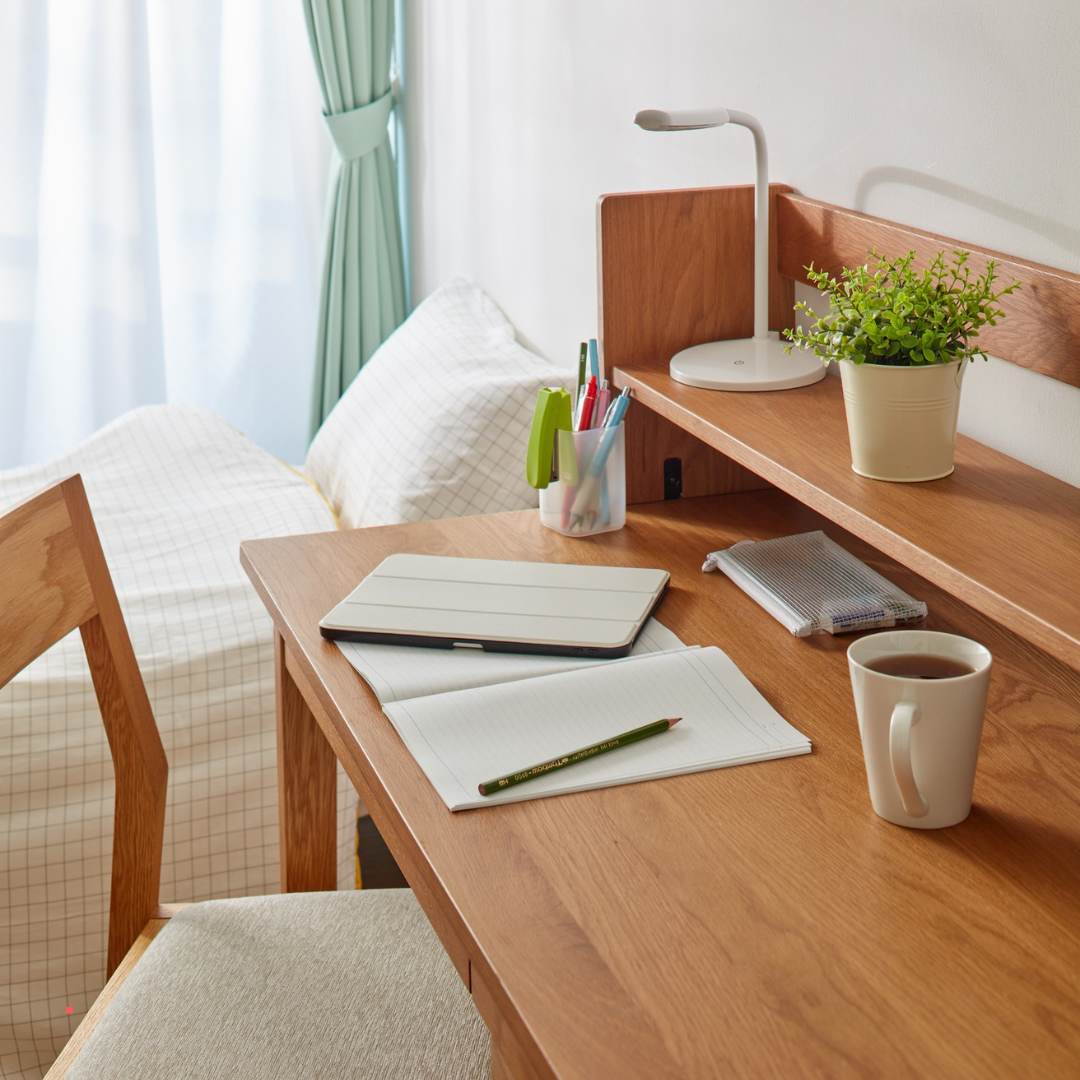 calm writing desk with notebook, pen, and coffee near a window
