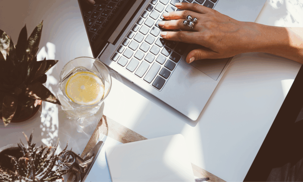 hand resting on laptop keyboard during a quiet writing or work moment