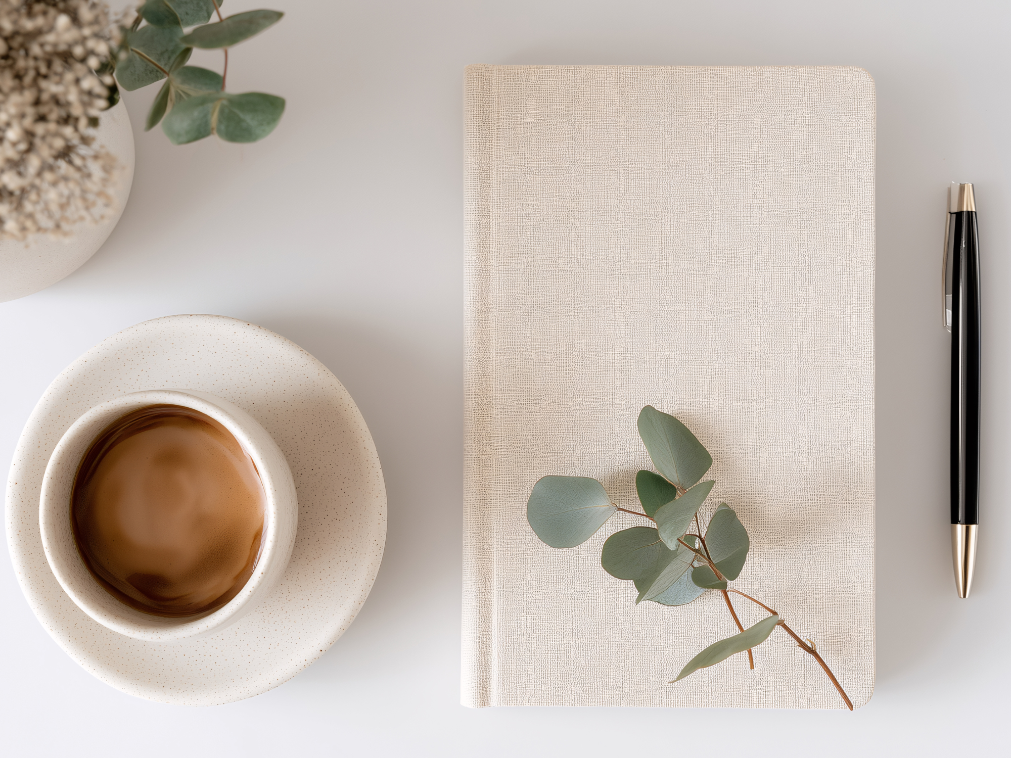 notebook and coffee arranged on a calm writing desk with soft natural light