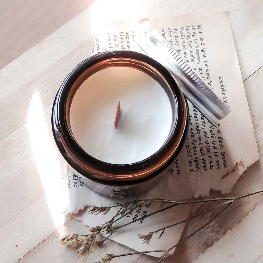 Candle placed on open book pages, evoking a slow and mindful atmosphere for emotional writing.