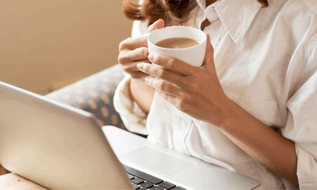 Cozy home writing ritual with laptop, notebook, and coffee in natural light