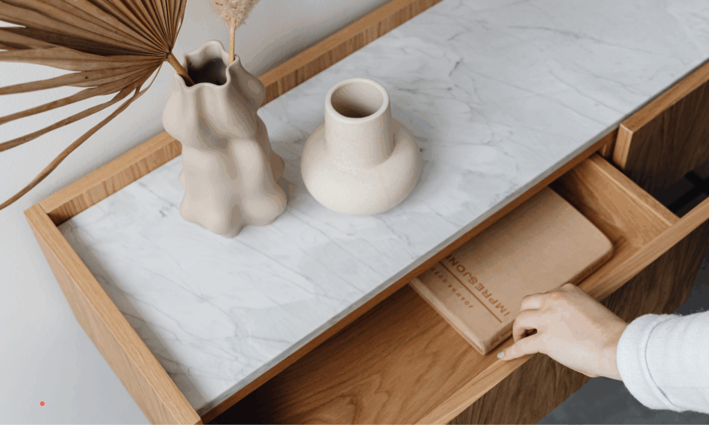 Hand reaching for a notebook from a drawer, symbolizing intentional journaling and creating a private writing space