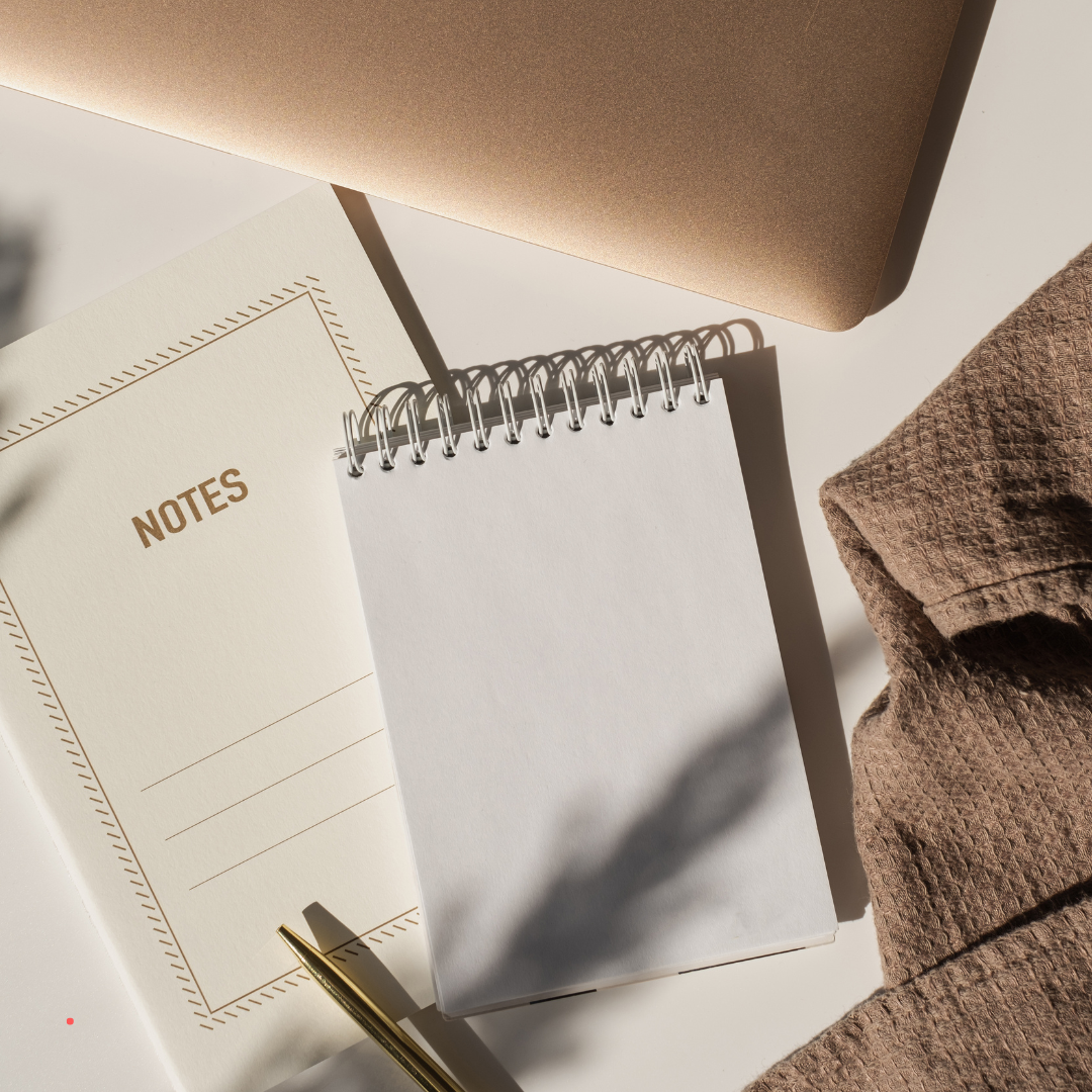 Blank notebook and notes in soft natural light, suggesting a moment of quiet journaling and clarity.