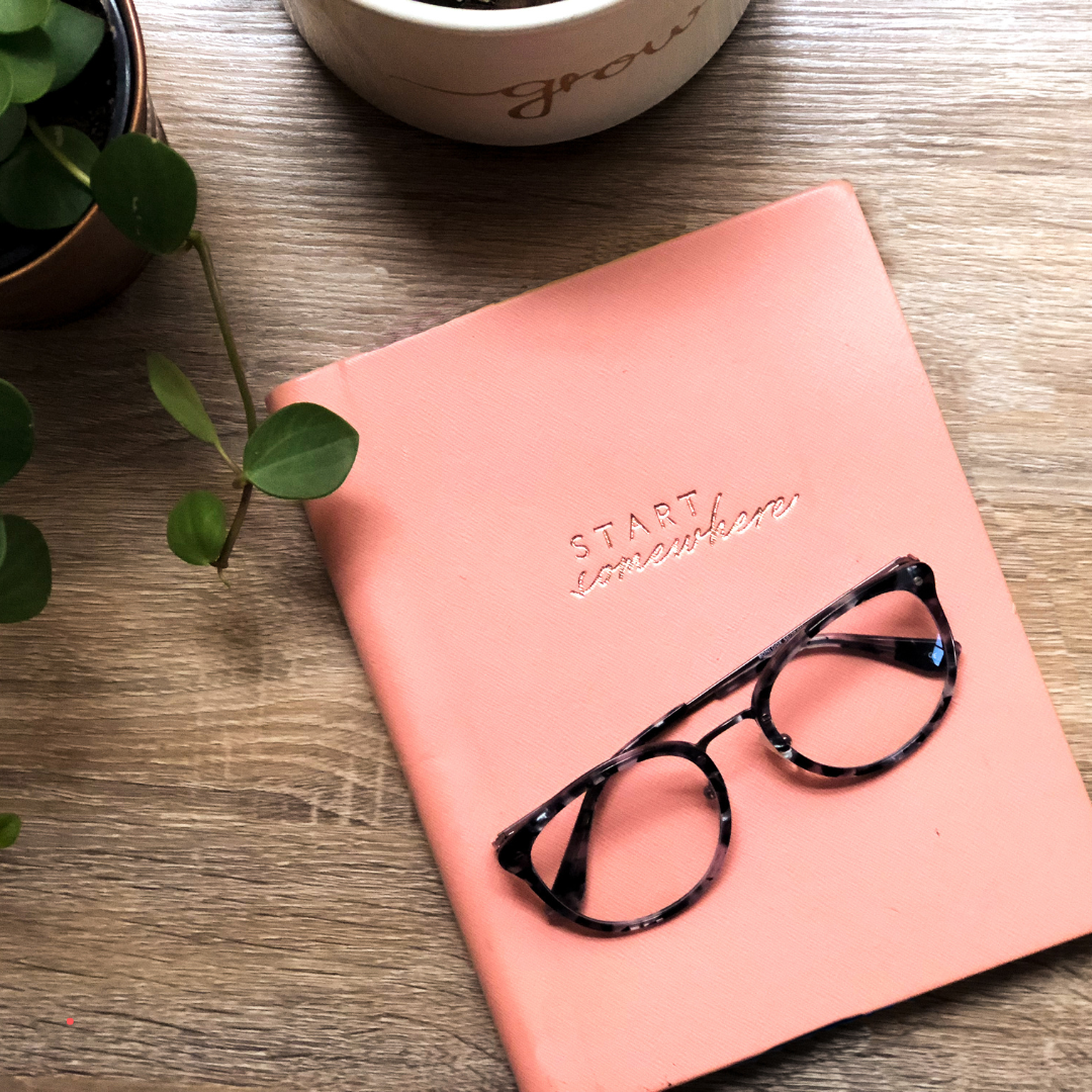 Notebook and coffee on a calm writing desk during a personal journaling and reflection practice