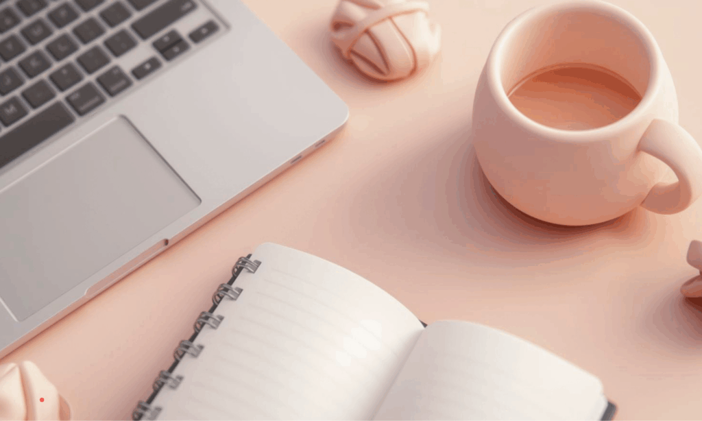 Notebook and coffee on a desk representing a gentle therapeutic writing and journaling routine