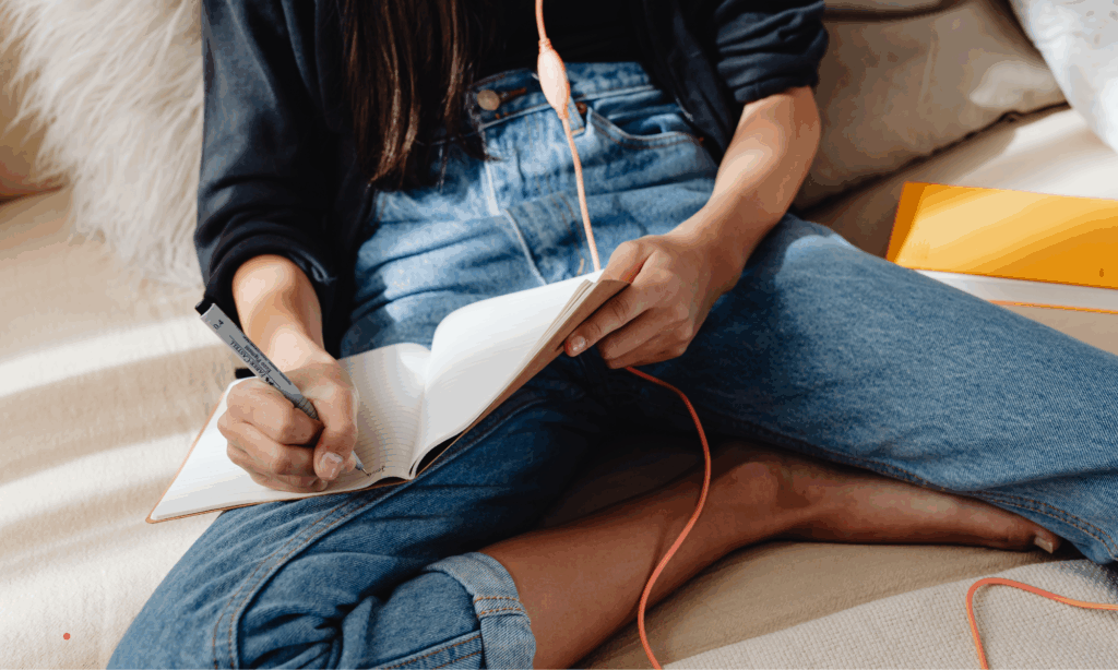 Journaling by hand during a relaxed self-reflection moment.