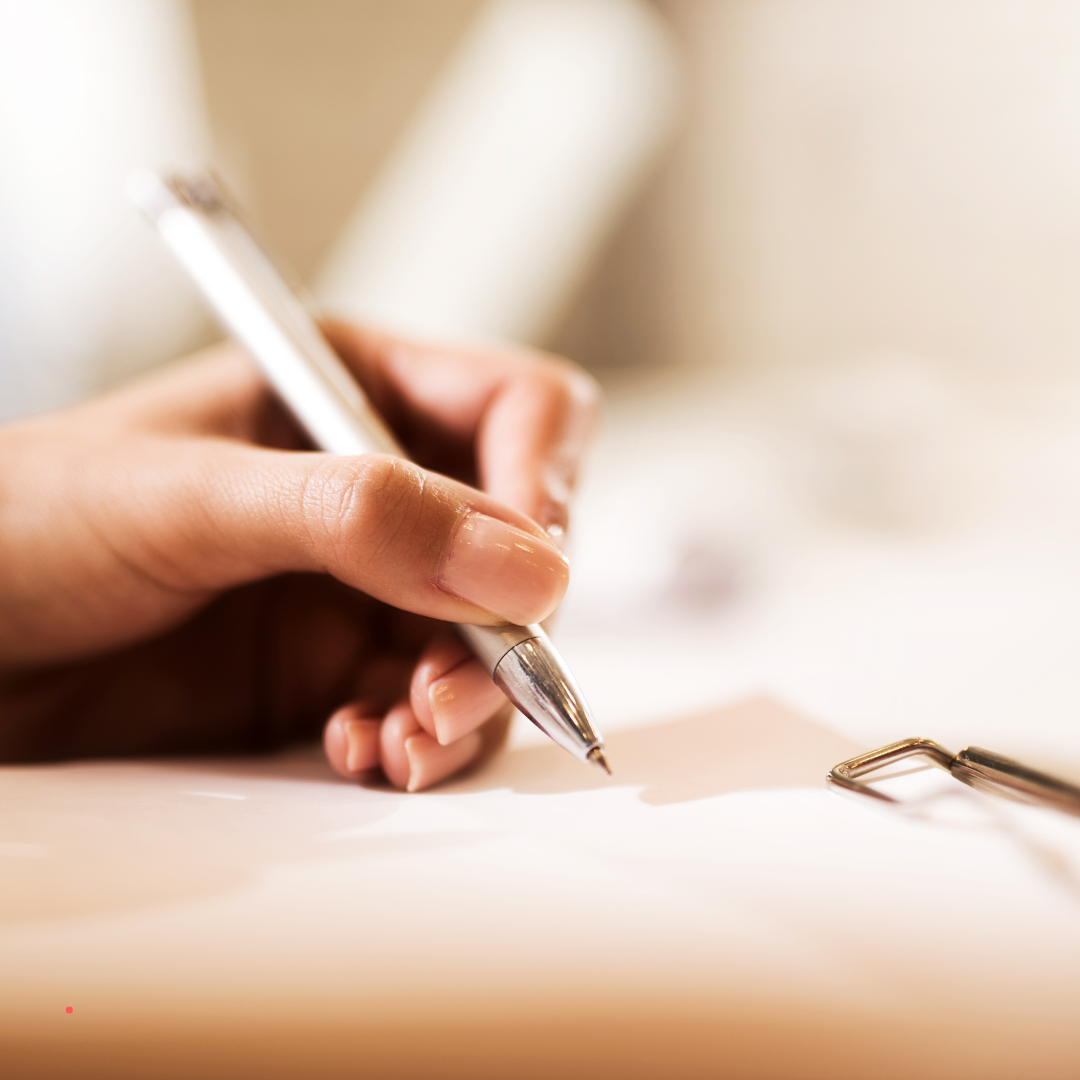 Handwriting notes in a quiet, focused writing moment.