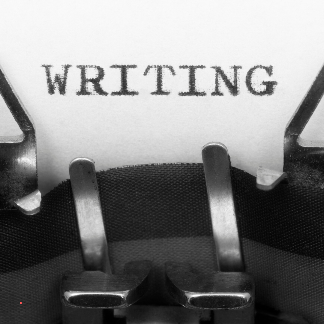 Close-up of the word “writing” on a typewriter symbolizing storytelling and expression