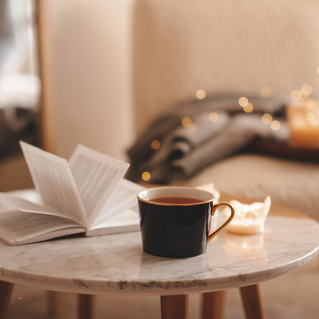 Open book and coffee on cozy table – peaceful atmosphere for journaling for letting go and emotional healing.
