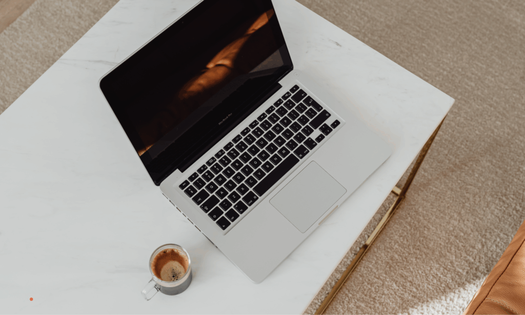 simple writing environment with laptop and coffee supporting a quiet journaling routine